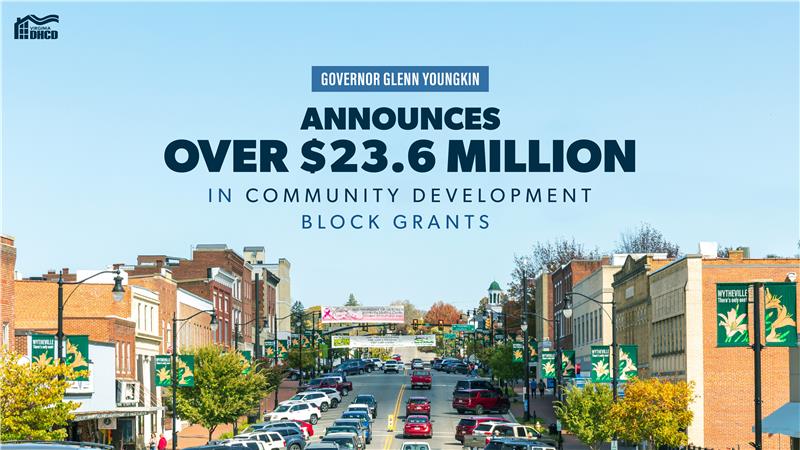 A street lined with brick shops and cars, with text reading "Inanunsiyo ni Gobernador Glenn Youngkin ang mahigit sa $23.6 milyon sa Mga Block Grant para sa Pagpapaunlad ng Komunidad